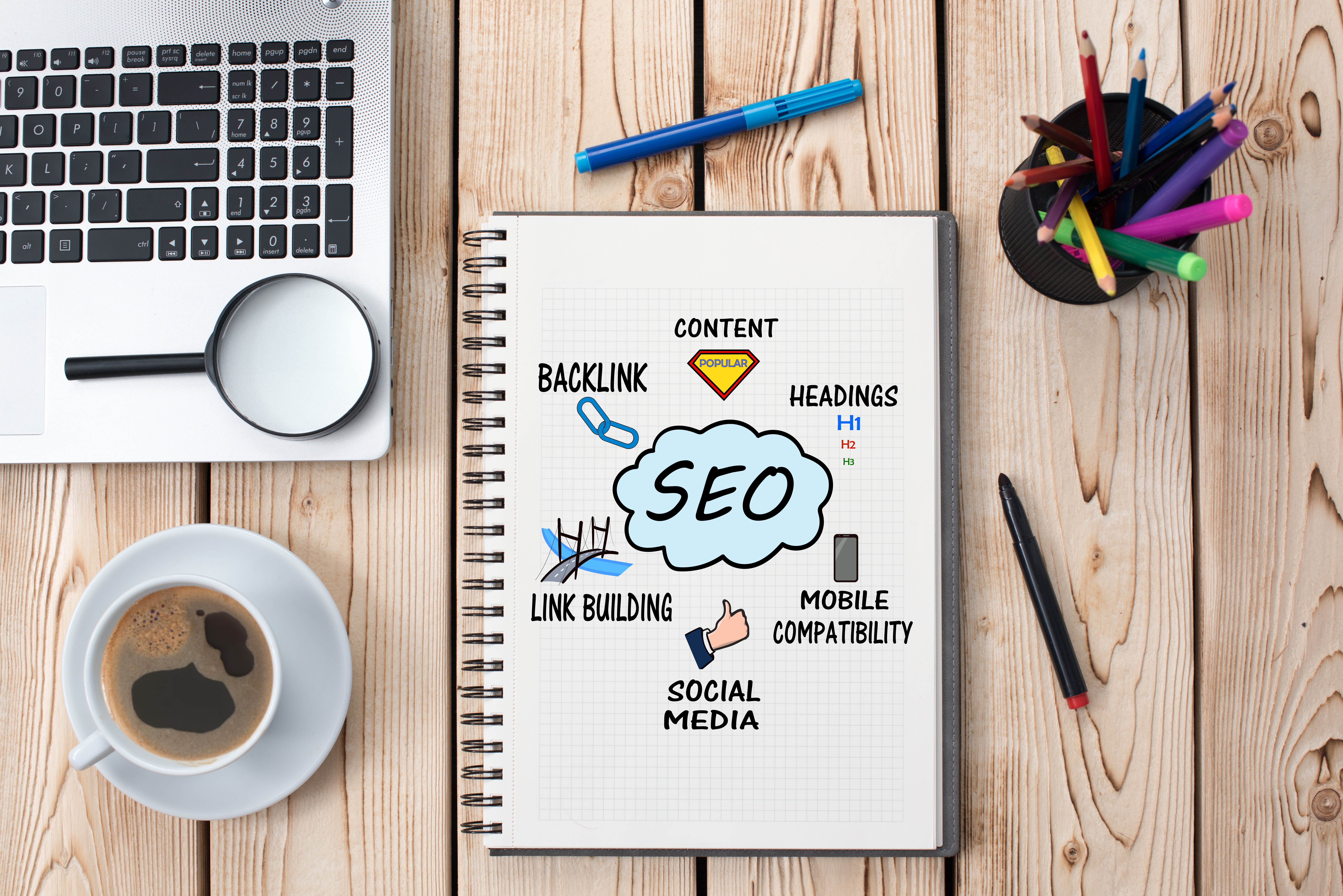 Creative desk and notebook with SEO on the cover