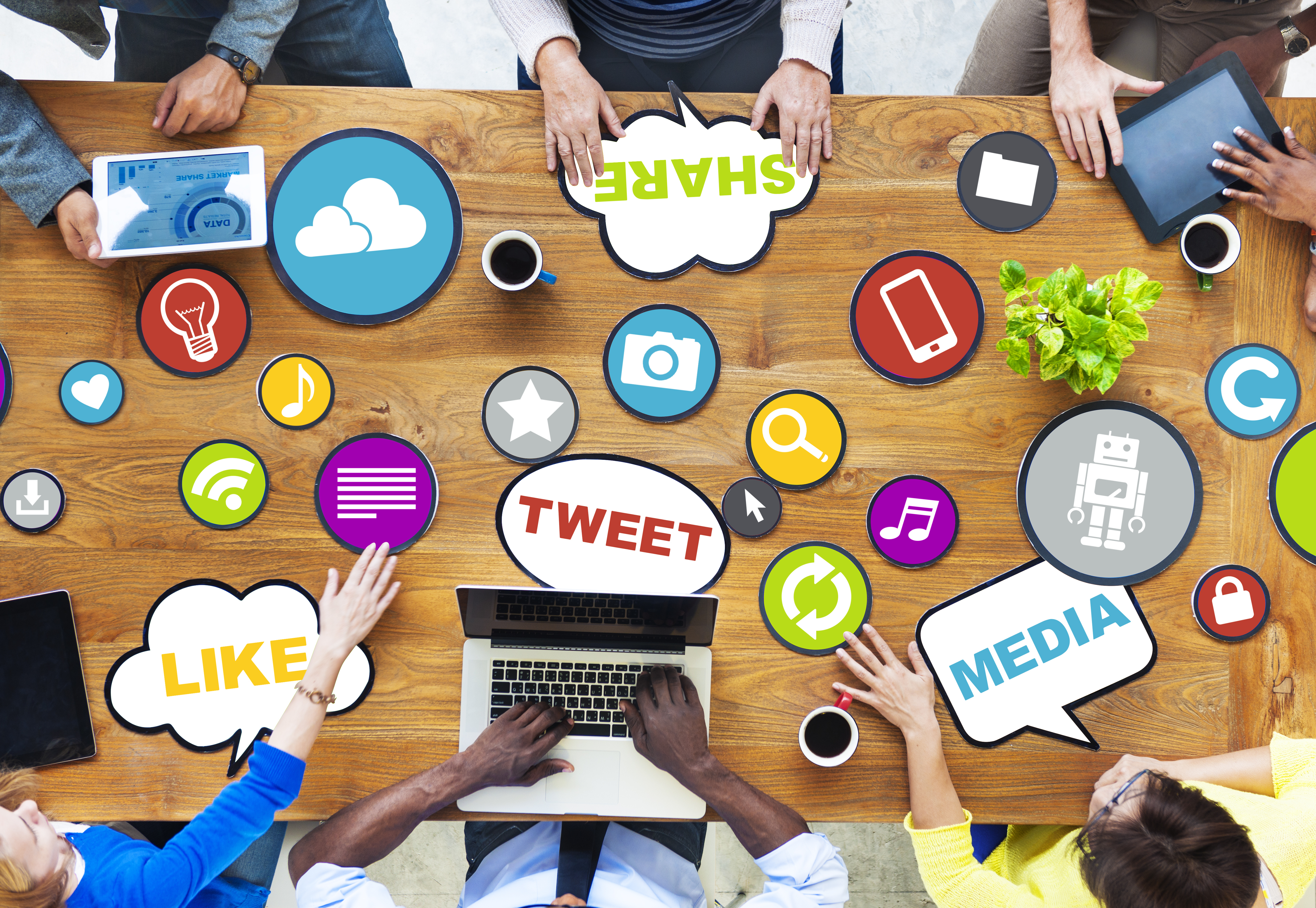 Many people at a desk with social media logos